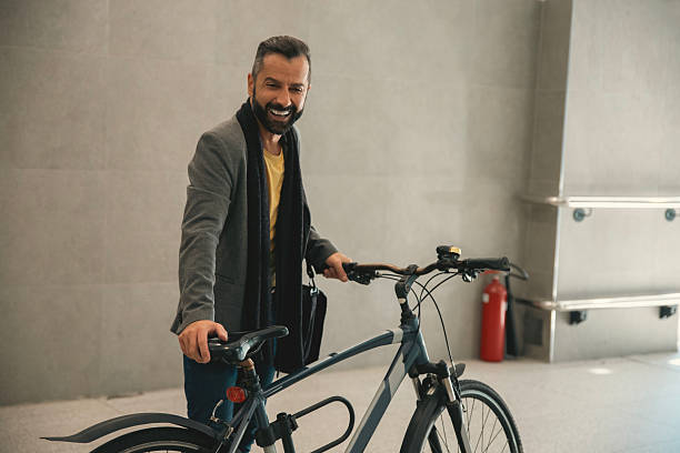 istock Man pushing a bicycle in building hall indoors 2246336146