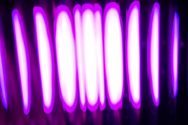 Abstract image of vertical light columns in vibrant purple and bright white, creating an intense, futuristic, and hypnotic digital pattern.