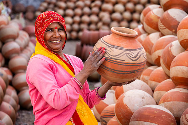 istock Smiling Potter Holding Terracotta Pot — Jaipur, India 2246337131