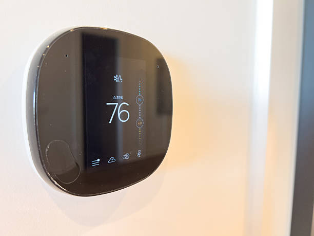 istock Black digital thermostat mounted near corner 2246337384