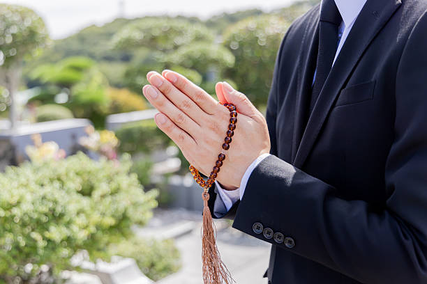 istock Asian man praying at a burial site 2246340383