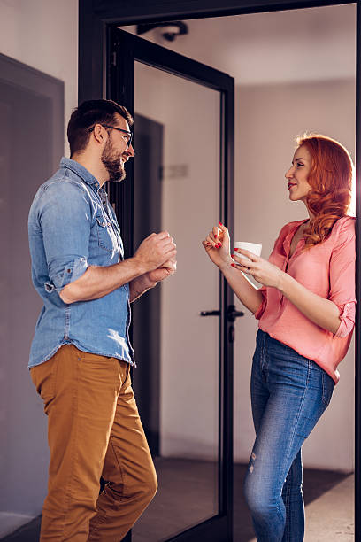 istock Cheerful office workers relaxing on a coffee break and chatting together. 2246340608