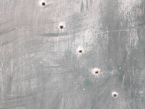 istock Metal Surface with Bullet Holes 2246340669