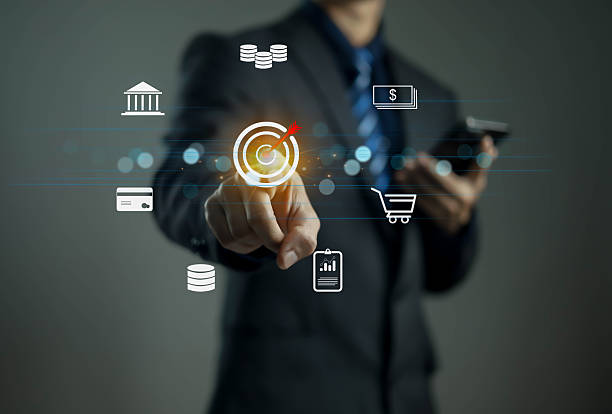 istock Businessman using digital technology to achieve financial goals, touching virtual target icons for online marketing, data analytics, e-commerce, and fintech innovation in modern business strategy. 2246341824