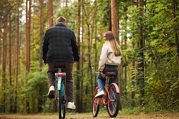 istock Young Man and Young Woman Riding Bicycles in Forest 2246341843