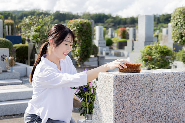 Withered flowers offered in front of the grave
