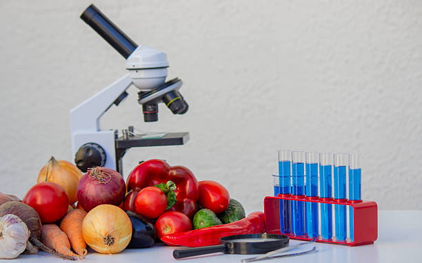 istock Microscope, test tubes, and fresh vegetables on a lab table for nutritional research 2246343194