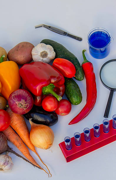 istock Microscope, test tubes, and fresh vegetables on a lab table for nutritional research 2246343205