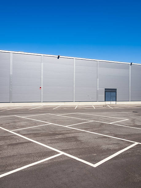 istock Empty parking area in front of a modern aluminium cladding building in Molndal, Sweden on a clear sunny day 2246343612