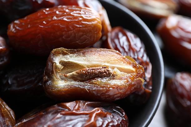 istock Many tasty dried dates in bowl, closeup 2246344443