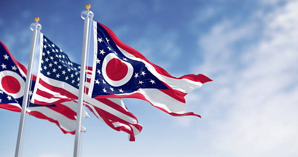 istock Ohio and national US flags waving in the wind on a clear day 2246346407
