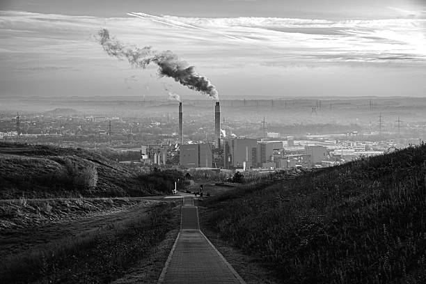 The gray column of smoke rising into the sky is the melancholic signature of the place - a visible sign of human activity in the quiet wide. The path itself invites contemplation: it does not lead into the void, but to a place of work and history. It is a philosophical look at the balance between the nature of the hill and the monumental presence of technology.