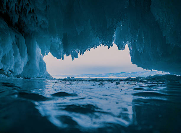 istock Inside a stunning ice cave on Lake Baikal, large icicles hang from the ceiling, creating a breathtaking winter landscape. Snow-covered mountains can be seen far in the distance. 2246356247