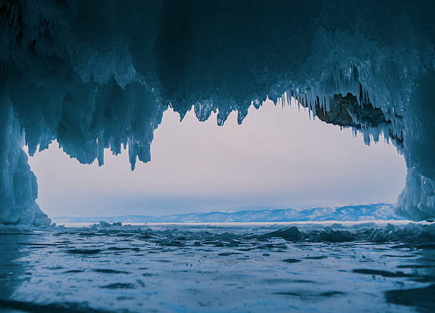 istock Inside a stunning ice cave on Lake Baikal, large icicles hang from the ceiling, creating a breathtaking winter landscape. Snow-covered mountains can be seen far in the distance. 2246356308