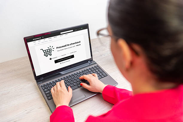istock Woman completing online purchase on laptop, checkout page visible, concept of e-commerce transaction, shopping, payment, and digital retail experience 2246357568