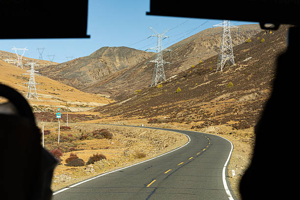istock Captivating view from inside a car showing a road curve and hills. 2246358278
