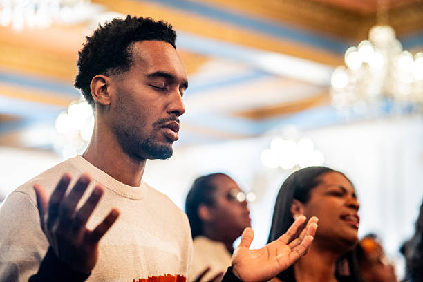 Young man praying on a church