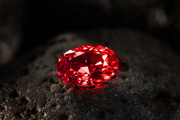 istock A red diamond is sitting on a rock 2246362452