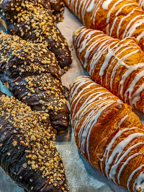istock Chocolate and Icing Croissants in Rows – Artisan Bakery Pastries with Nuts and Glaze for Gourmet Branding, Food Styling. Creative Background 2246363549