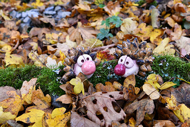 Pottery ceramic hedgehog with colorful autumn leaves