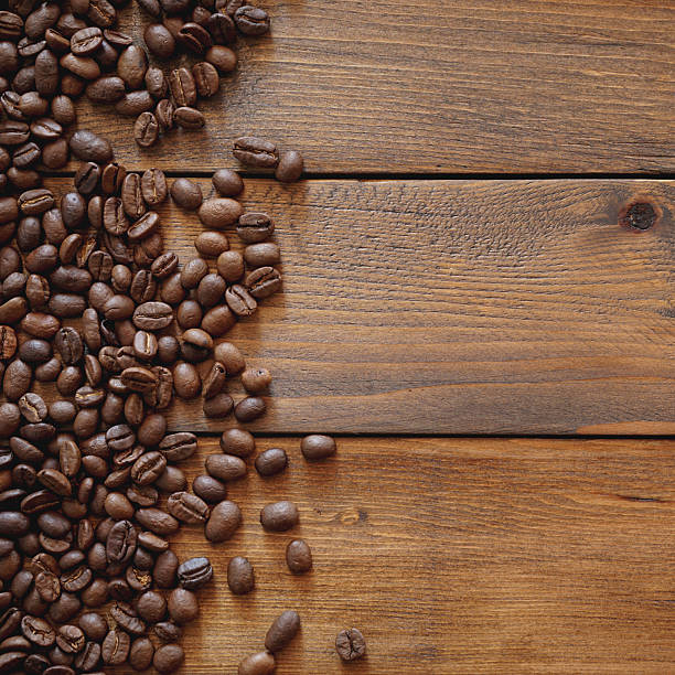istock Coffee beans on brown wood background with copy space 2246364615
