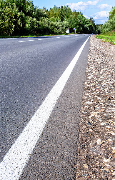 istock A solid white line marking on an asphalt road in countryside 2246364683
