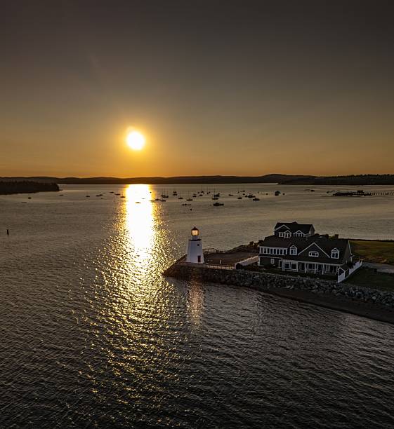 istock Scenic sunset over harbor with lighthouse. 2246368311