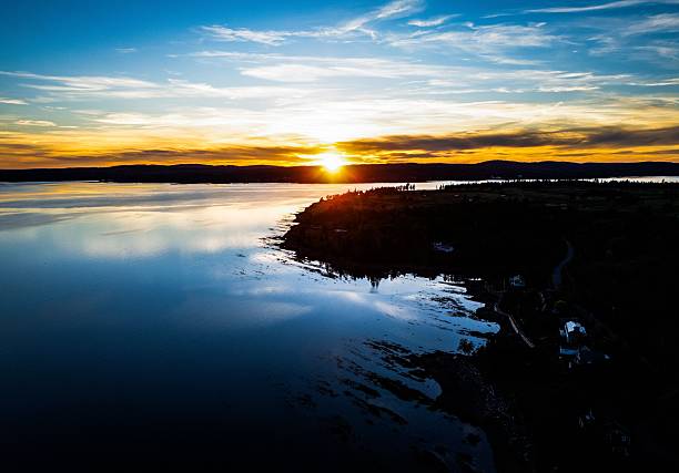 istock Sunset over tranquil lake with vibrant reflections. 2246368334