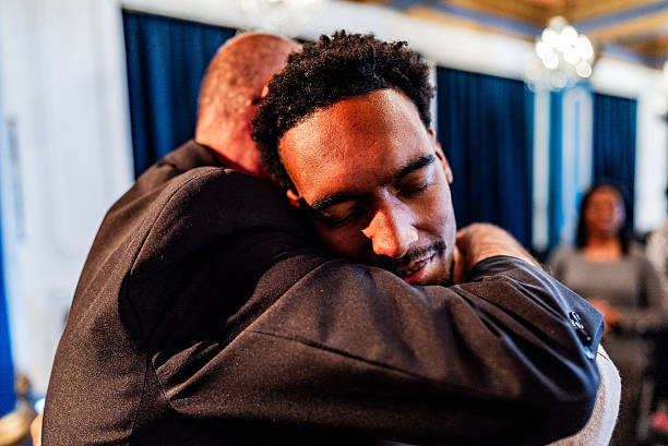 istock Pastor embracing faithful during religious moment 2246369815