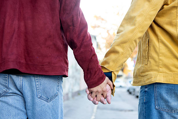 Gay couple in a city. Both about 40 years old, Caucasian male.
