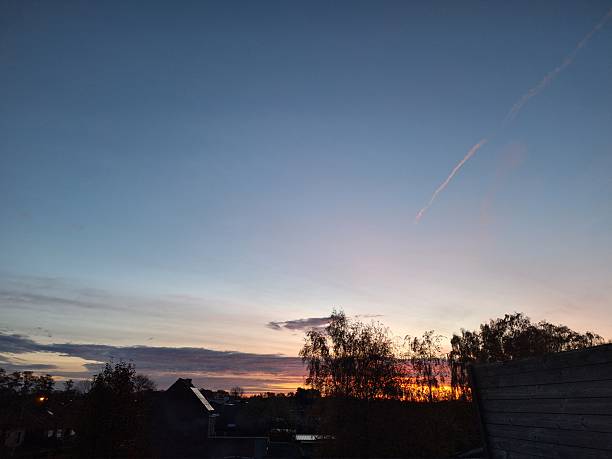 Sunset casting warm hues over rural landscapes and open farmland