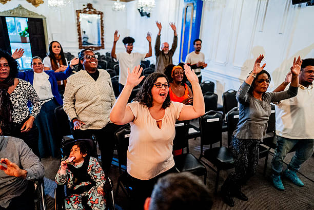 istock Worshippers raising hands during passionate church service 2246371786