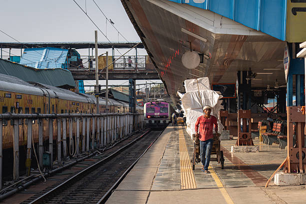 Delhi, India - September 15, 2025: Trains and people on the railway platform at New Delhi Railway Station