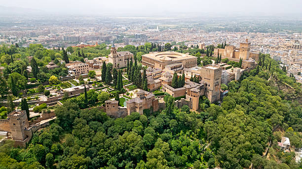 Aerial view of Alhambra, and city of Granada in fog in background, Spain