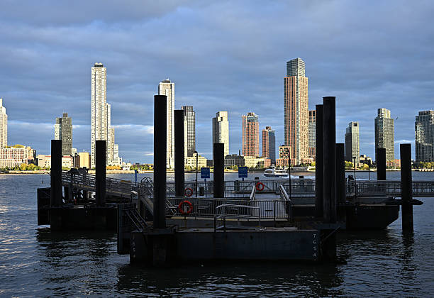 New York, NY, USA -- 2025: 34th Street ferry landing with ferry on way to Brooklyn