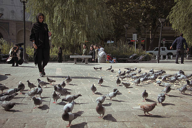 Tehran, Iran - October 07, 2017 - People in the vicinity of Tehran's Grand Bazaar and the pigeons being fed