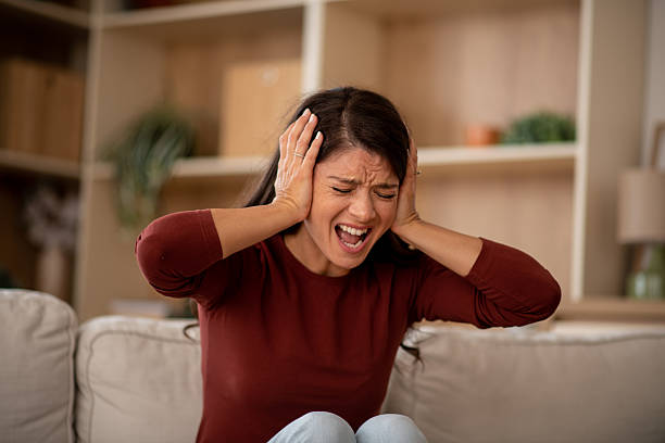 istock Woman shouting in pain from severe headache 2246378601