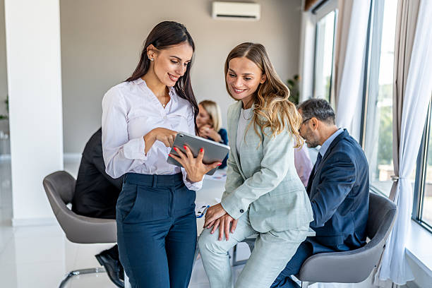istock Businesswomen discussing project on digital tablet in office 2246383716