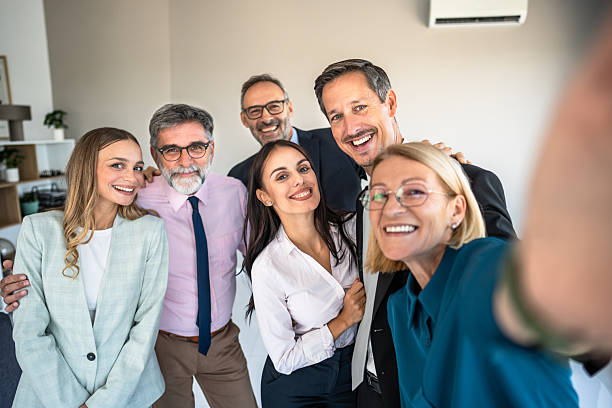 istock Happy multi-generational business team taking a selfie in office 2246384375