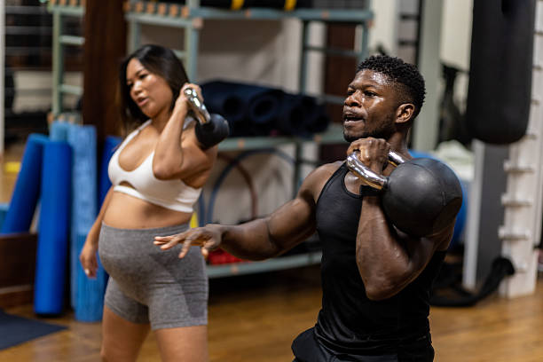 istock Fit Couple Multiracial Working Out with Kettlebell 2246385942