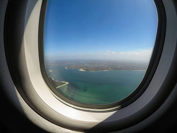 istock Beautiful aerial ocean view by looking through an airplane window. 2246389470