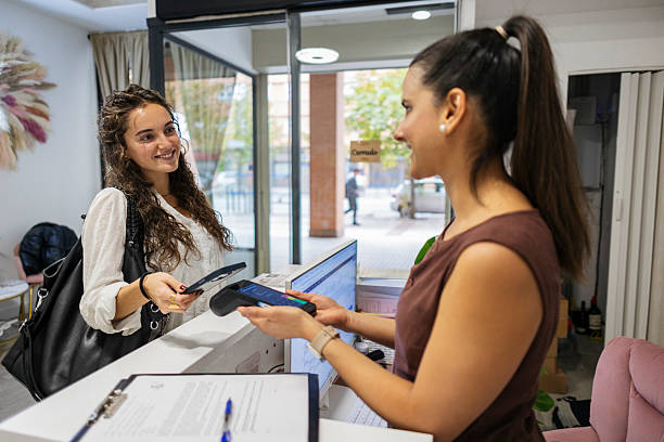 istock Customer making contactless payment at small business reception 2246389815