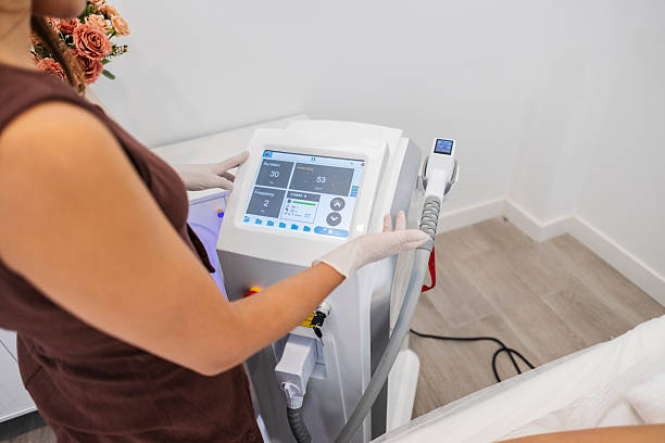 istock Aesthetician adjusting settings on laser hair removal machine 2246390094