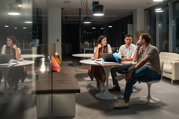 istock Diverse Business Executives Engaging in Late-night Strategy Session in Modern Office 2246390252