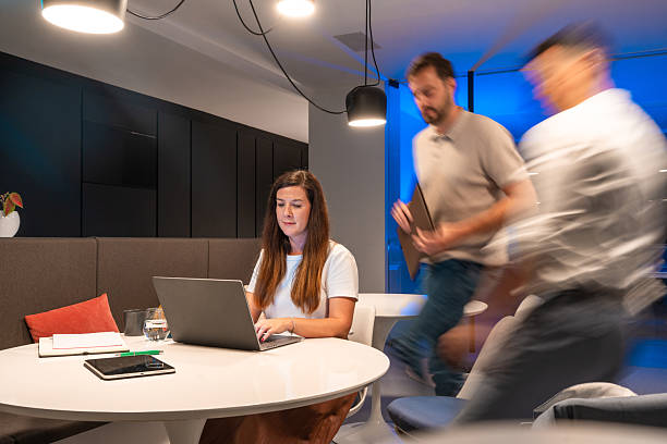 istock Focused Caucasian Woman Engaged in Late-night Work at Modern Office 2246390355