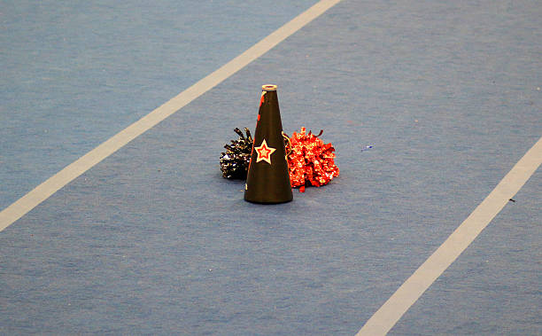 istock Cheerleading Accessories on a Gym Floor During Practice Session 2246390393