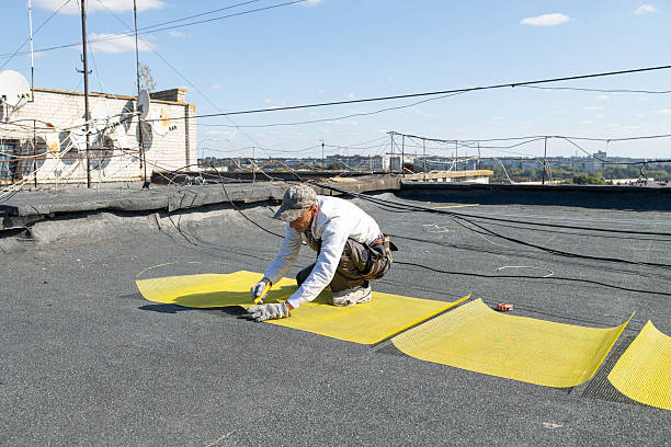 istock Construction worker cuts the yellow reinforcing mesh into two pieces with the utility knife. 2246391156