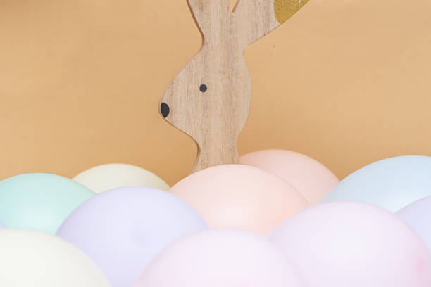 easter bunny with beige background and soft colored balls