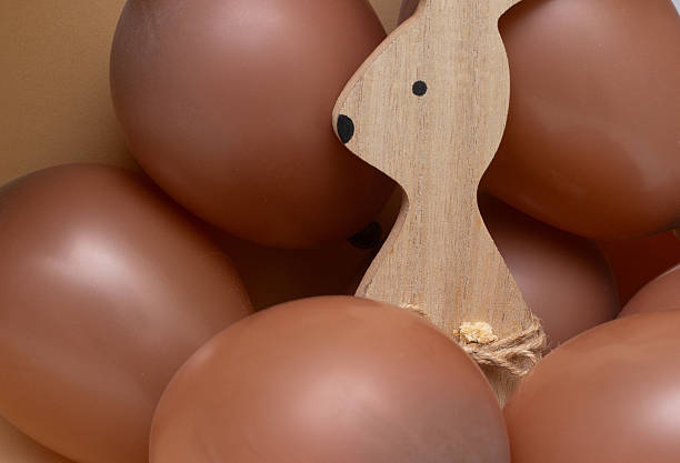 easter bunny with beige background and chocolate colored balls