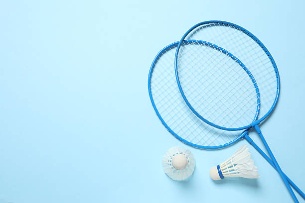 istock Badminton rackets and white badminton shuttlecocks on color background 2246392909